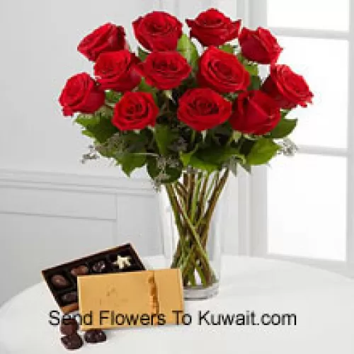 12 Red Roses With Some Ferns In A Vase And A Box Of Godiva Chocolates (We reserve the right to substitute the Godiva chocolates with chocolates of equal value in case of non-availability of the same. Limited Stock)